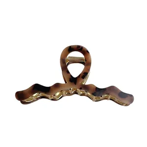Retro tortoiseshell acetate hair claw clip with gold metal frame for elegant hairstyling