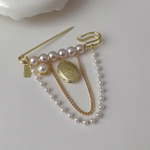 Vintage gold brooch with pink pearls, tassel chains and pendant for elegant suit styling