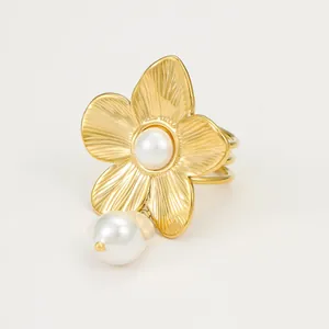 Elegant gold flower ring with pearl pendant and triple-band stainless steel design