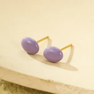 Macro detail of glossy purple bean earrings with 18K gold plated steel studs