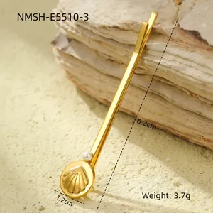 Detail showing 6.2cm gold seashell hair clip with white pearl on rock background