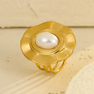 Minimalist gold stainless steel ring featuring irregular wave disc and large oval pearl