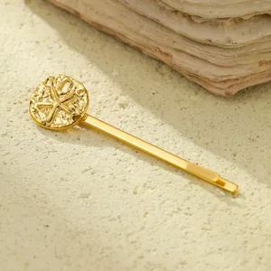 Detailed macro of golden starfish embossed hairpin with a luxury hammered texture finish