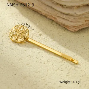 Detail view of a 1.55cm gold shell hair clip with wave texture and star embossment