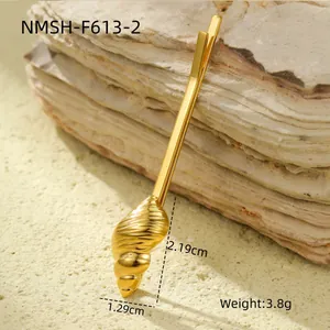 Detail view of gold conch shell hair clip with size measurements and weight data