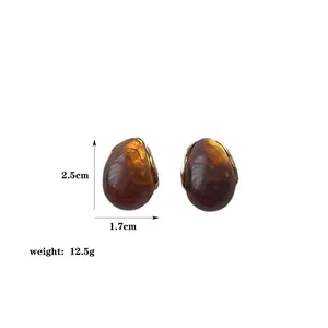 Detailed view of resin drop earrings with 2.5cm height and gold metal frame dimensions