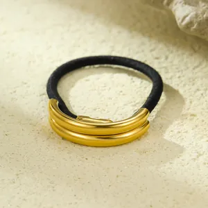 Elegant multi-layer gold metal arc hair tie with elastic black band on stone