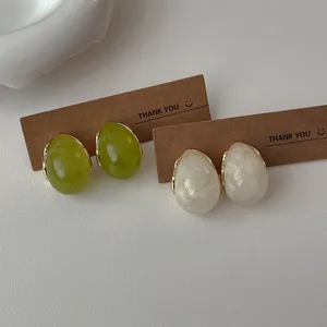French vintage resin waterdrop earrings in green and milky white with gold metal trim