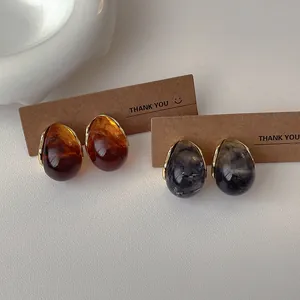 French vintage resin teardrop earrings in amber brown and smoky grey with gold accents