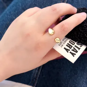 Minimalist gold open ring featuring irregular pebble design in a polished mirror finish
