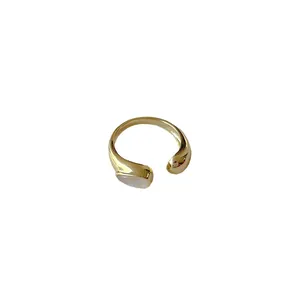 Minimalist gold shell ring with asymmetric band and white teardrop inlay