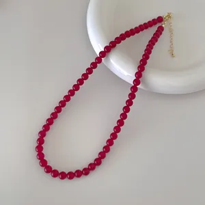 Detail of red agate beaded necklace with gold adjustable lobster clasp and extension chain