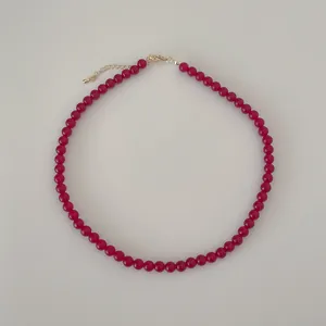 Detail of red agate beaded necklace showing gold lobster clasp and adjustable chain extender