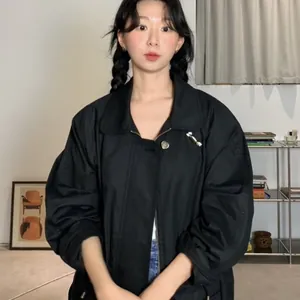 Minimalist black jacket with silver candy shaped metal brooches and heart pins