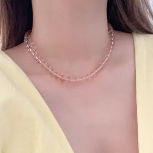 Minimalist pink beaded necklace for women shown on a model with a warm summer style