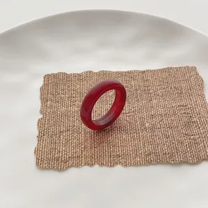 Roter Karneol-Achat-Ring mit glattem, lichtdurchlässigem Finish auf Keramiktablett