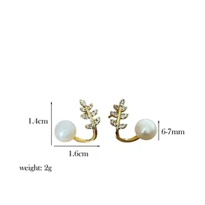 Detail view of pearl earrings with dimensions: 1.4cm height, 1.6cm width and 7mm pearls