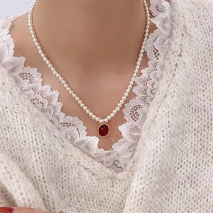 French vintage pearl necklace with red agate pendant and gold metal accents for women