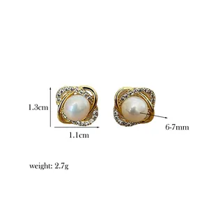 Detail view of gold pearl earrings with dimensions 1.3cm by 1.1cm and weight 2.7g
