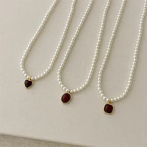 French vintage pearl necklaces with geometric red agate pendants in heart and oval shapes