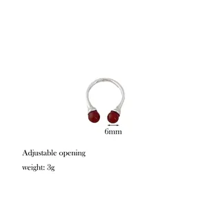 Detail showing 6mm red agate beads and adjustable opening feature on the silver ring