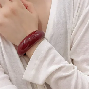 Minimalist deep wine red resin open bangle bracelet with a smooth polished finish