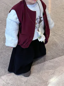 Toddler three-piece autumn set with burgundy vest and plush rabbit pendant accessory
