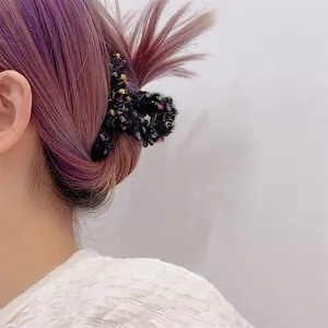 Elegante pinza de pelo de tweed para coleta alta sobre fondo de cabello púrpura