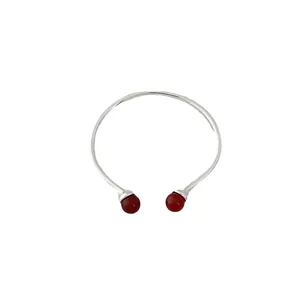 Silver open bangle bracelet featuring two polished red agate stone beads on white background