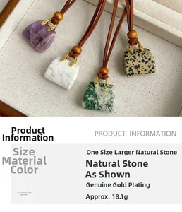 Detail of natural stone pendants in mini bag shapes with premium gold-plated finish