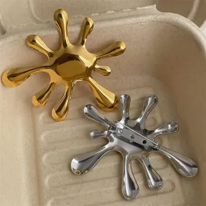 Vintage irregular water ripple brooch set in polished gold and silver metal finishes