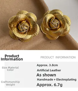 Detailed macro view of 3.8cm gold fabric rose earrings with realistic leather texture
