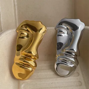 Abstract metal face brooches in gold and silver finish with liquid mirror texture