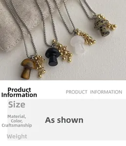 Detailed view of mushroom pendants in tiger eye, obsidian, and quartz on silver chains