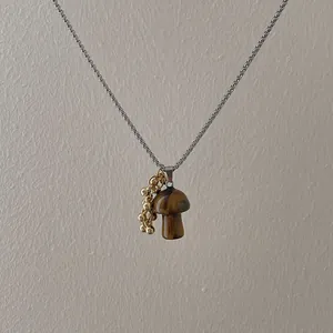 Tiger eye mushroom pendant on silver box chain necklace with gold bead accents
