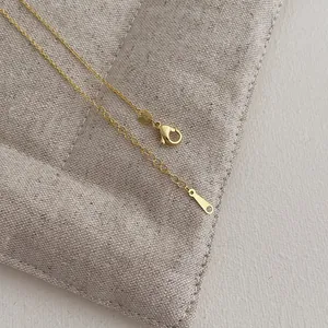 Close-up of S925 sterling silver lobster clasp and extension chain with metal tag