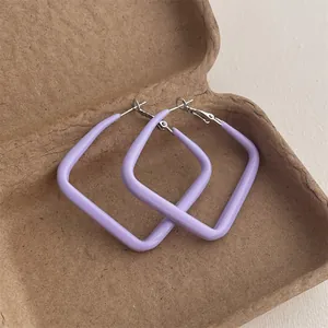 Macro detail of large lavender square hoop earrings with polished silver metal clasps