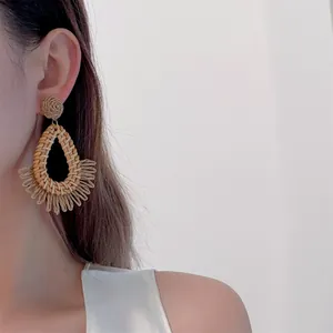 Handmade woven raffia teardrop earrings in bohemian style for beach vacations