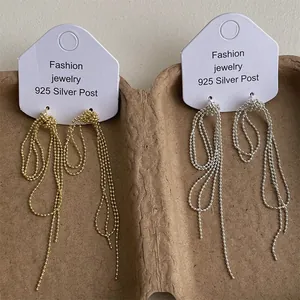 Detail of gold and silver tassel earrings with 925 silver posts on display card
