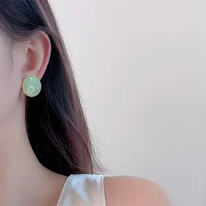 Detail of vintage French floral enamel earring with pearls on model ear