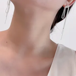 Close-up of S925 silver long tassel earrings with layered chain drop on female model