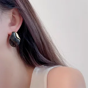 Elegant amber resin drop earrings with gold metal accents on model for a vintage look