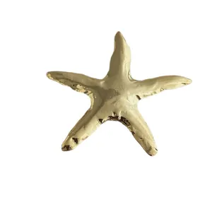 Elegant gold starfish brooch with a high-polished mirror finish for suits and coats