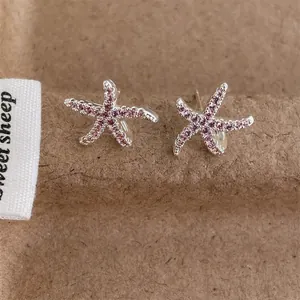 Exquisite starfish stud earrings with pink cubic zirconia in silver metal finish