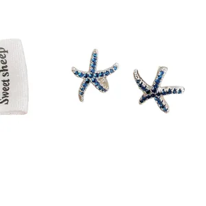 Elegant starfish stud earrings with blue cubic zirconia and silver finish in ocean style