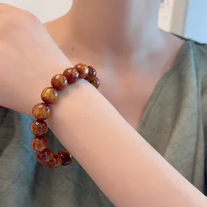 Bracciale cinese in perle di legno con trama in seta dorata per uomo e donna