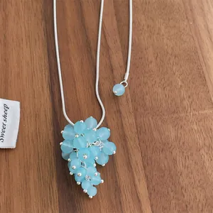 Adjustable silver chain necklace with light blue translucent beaded grape cluster pendant