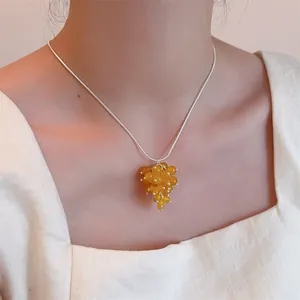 Adjustable silver snake chain necklace with yellow grape cluster resin pendant