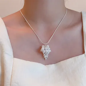 Detailed close-up of a white pearl grape cluster pendant on a sleek silver snake chain
