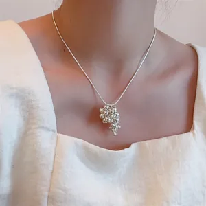 Detailed view of silver grape cluster pendant necklace on delicate snake chain